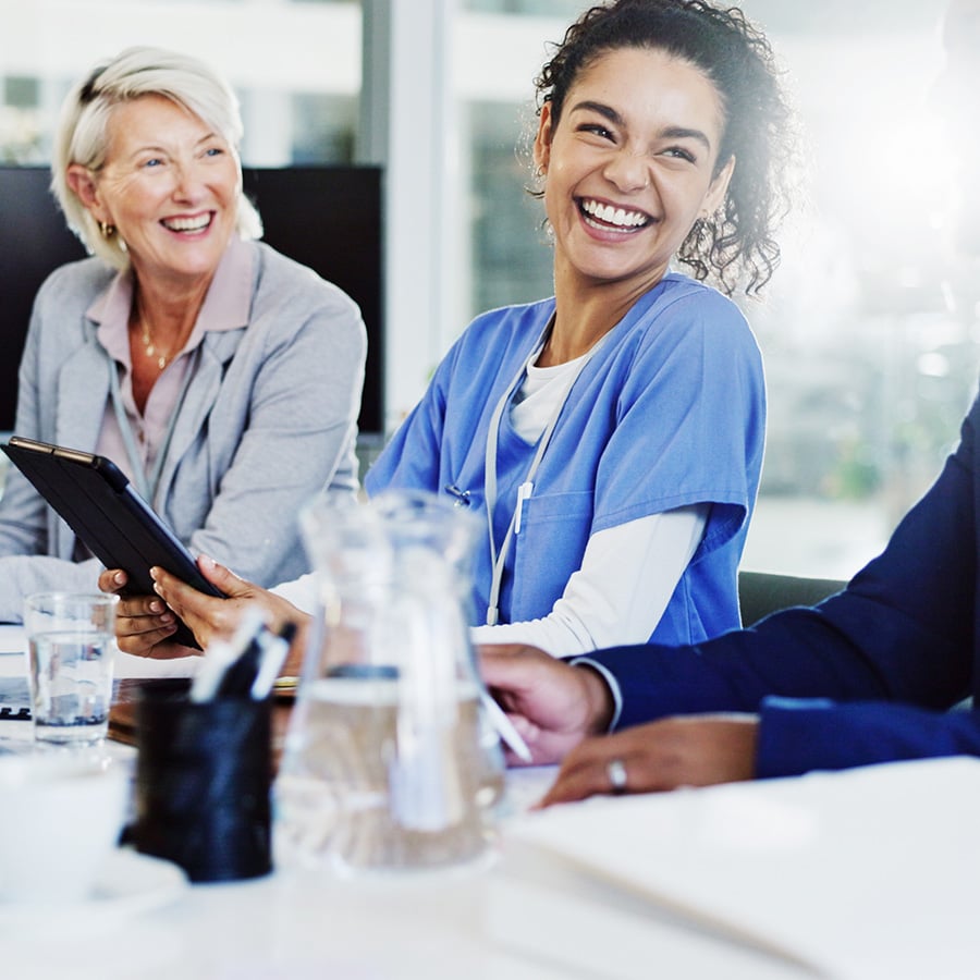 Boardroom, healthcare and laughing with hospital manager speaking to staff for medical planning.