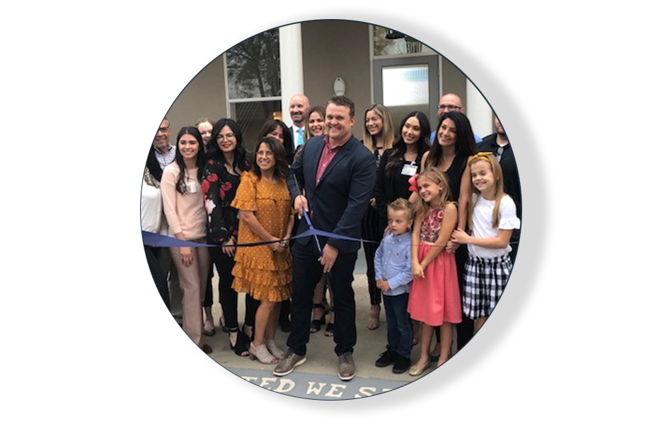 corporate employees cutting ribbon at ceremony